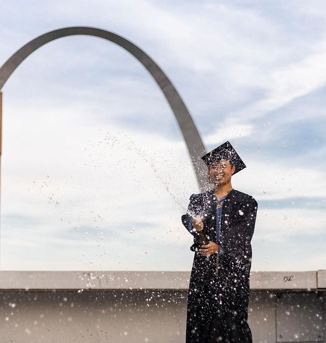 Anh Nguyen celebrates his college graduation with St. Louis’ iconic Gateway Arch in the background.