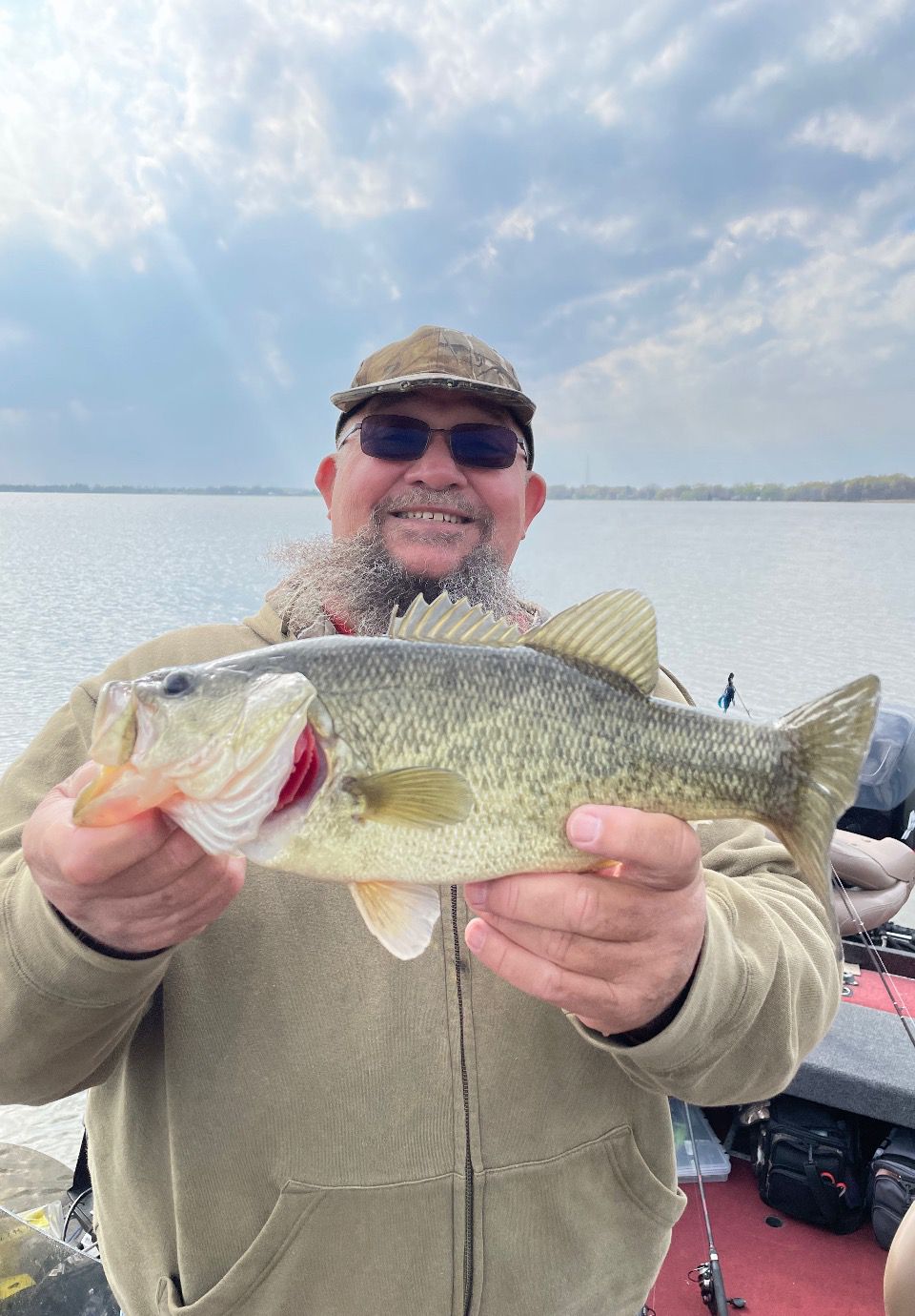 Bob Evans from Marquette, Wisconsin  with a Fox Lake bass; guide Mike Norris texted, “Notice how the color of this bass changed due to the dirty water.” Provided photo