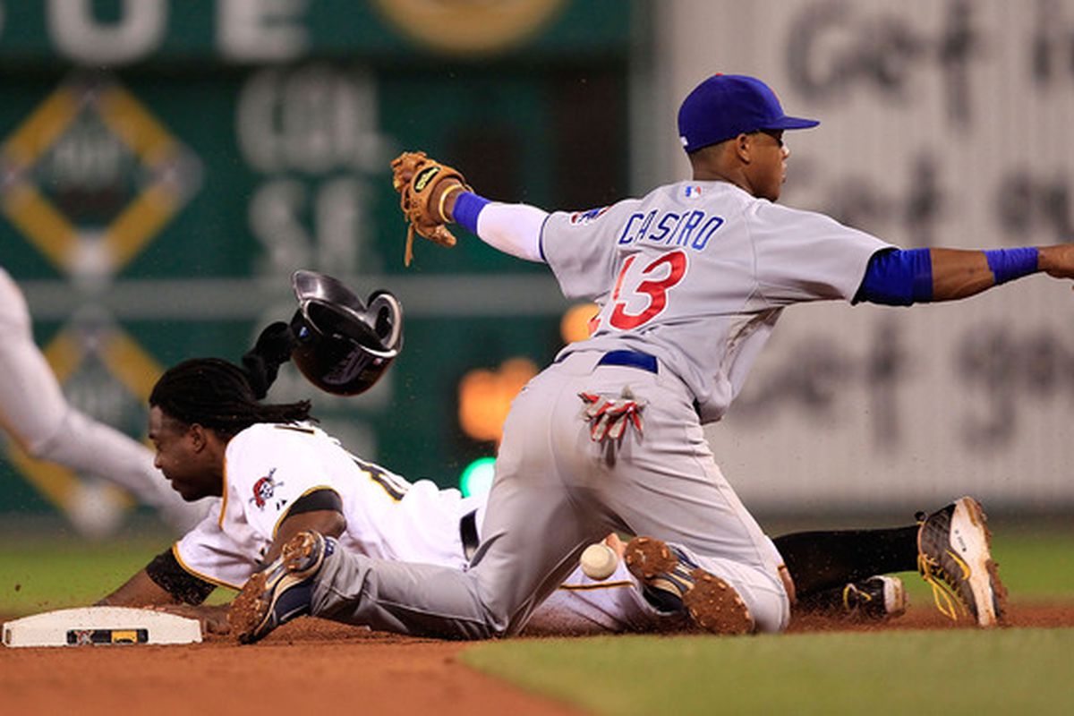 PITTSBURGH - JUNE 01:  Starlin Castro #13 of the Chicago Cubs misses the tag on Lastings Milledge #85 of the Pittsburgh Pirates on June 1, 2010 at PNC Park in Pittsburgh, Pennsylvania.  (Photo by Jared Wickerham/Getty Images)