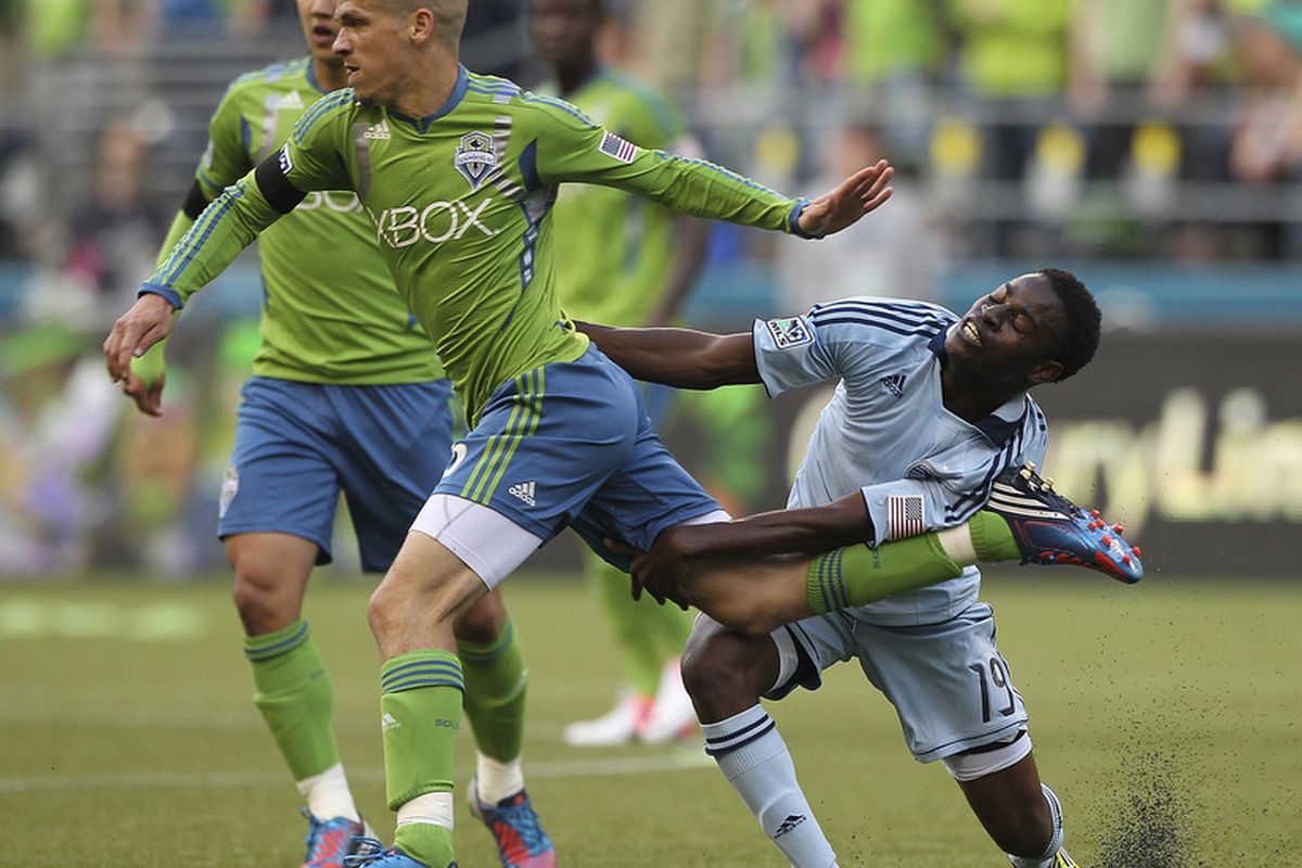SEATTLE, WA - JUNE 20:  Osvaldo Alonso #6 of the Seattle Sounders battles Peterson Joseph #19 of Sporting Kansas City at CenturyLink Field on June 20, 2012 in Seattle, Washington. (Photo by Otto Greule Jr/Getty Images)