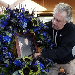 WVC Police Department photographer Kevin Conde places a portrait of officer Cody Brotherson in a memorial at the public safety building in West Valley City on Monday, Nov. 7, 2016. Officer Brotherson was killed while trying to help stop a fleeing car during a chase early Sunday morning.