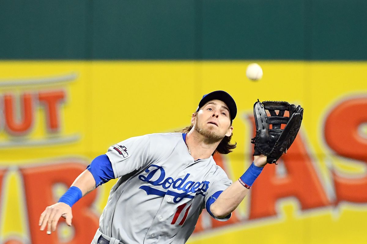 Josh Reddick catches a ball for the Dodgers, who beat the Nationals in the playoffs.