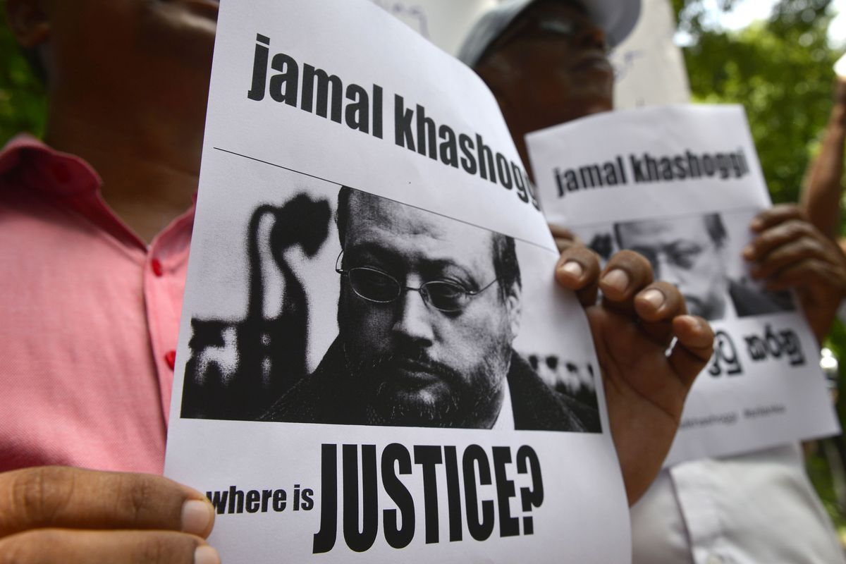 Members of the Sri Lankan web journalist association hold placards with the image of Saudi journalist Jamal Khashoggi during a demonstration outside the Saudi Embassy in Colombo on October 25, 2018,