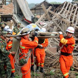 In this photo released by China's Xinhua News Agency, rescuers carry out an elderly paralyzed person from a collapsed house after an earthquake struck, in Qingren Township, Lushan County, Ya'an City, southwest China's Sichuan Province, Saturday, April 20, 2013. A powerful earthquake struck the steep hills of China's southwestern Sichuan province Saturday morning, leaving at least 160 people dead and more than 6,700 injured. 