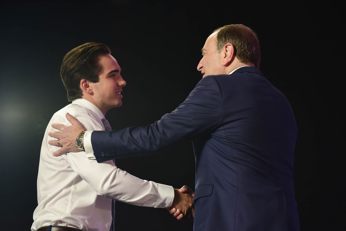 Alex Newhook greets NHL commissioner Gary Bettman after being selected as the number sixteen overall pick to the Colorado Avalanche in the first round of the 2019 NHL Draft at Rogers Arena.