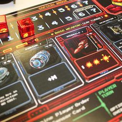 Each ship's player board contains tracks for threats and energy, as well as slots for various card upgrades like weapons, engines, and shields, in The Battle of Kemble's Cascade, from Z-Man Games.