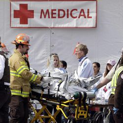 Medical personnel work outside the medical tent in the aftermath of two blasts which exploded near the finish line of the Boston Marathon in Boston, Monday, April 15, 2013. 