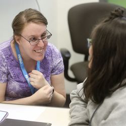 Jessica Drake, a special education paraprofessional, teaches Alexis Garcia about emotions at the American International School of Utah in Murray on Friday, May 3, 2019.
