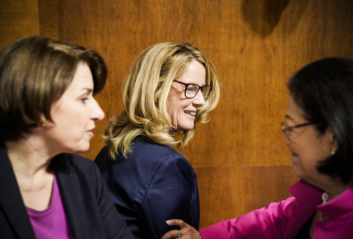 Christine Blasey Ford is greeted by Sen. Mazie Hirono (D-Hawaii) and Sen. Amy Klobuchar (D-Minn.), left, during a break in her testimony before the Senate Judiciary Committee on September 27, 2018.