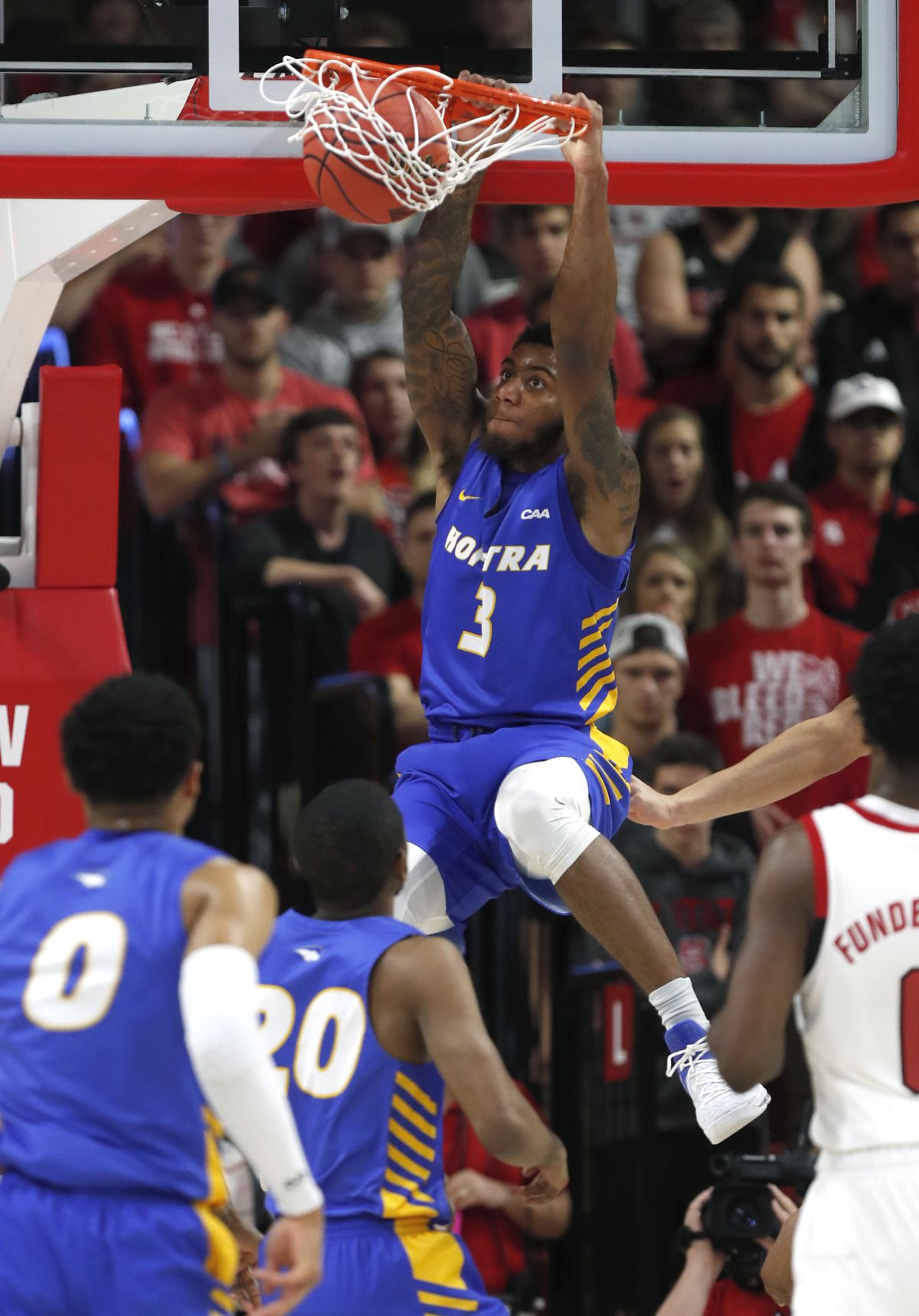 Hofstra's Justin Wright-Foreman (3) slams in two against North Carolina State during the first half of an NCAA college basketball game in Raleigh, N.C., Tuesday, March 19, 2019. (Ethan Hyman/The News & Observer via AP)