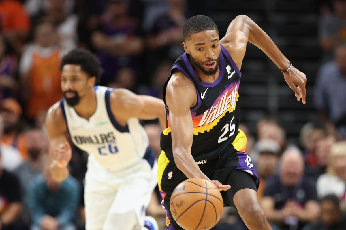 Mikal Bridges #25 of the Phoenix Suns steals the ball from Spencer Dinwiddie #26 of the Dallas Mavericks during the second half of Game Five of the Western Conference Second Round NBA Playoffs at Footprint Center on May 10, 2022 in Phoenix, Arizona.