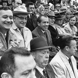 FILE - In this Dec. 6, 1969, file photo President Richard M. Nixon, center, watches "The Big Shootout" football game between Arkansas and Texas in the stands at Razorback Stadium in Fayetteville, Ark. The NFL, which is trying to maintain its TV blackout of home games that don't sell out, missed an opportunity 40 years ago, 1972, to keep an even more restrictive policy in place when it rebuffed an effort by Nixon to at least televise playoff games. In the row with Nixon, from left, are Rep. John Paul Hammerschmidt, R-Ark., Ark. Gov. Winthrop Rockefeller, Sen. John L. McClellan, D-Ark., Sen. J. William Fulbright, D-Ark., Rep. George H. Bush, R-Tex. Ranked No. 1, Texas won the game and the national championship by defeating No. 2 Arkansas 15-14.