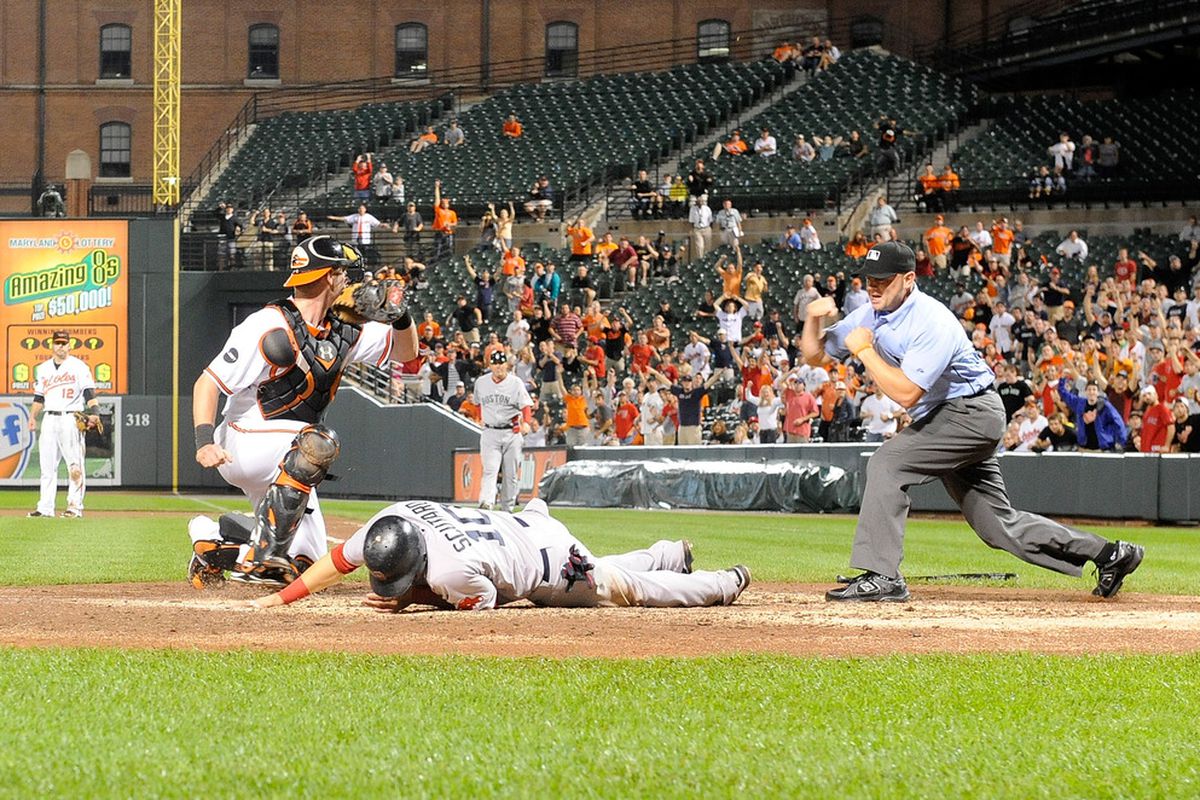 Marco Scutaro #10 of the Boston Red Sox is tagged out at home plate in the eighth inning on Sept 28 by Matt Wieters #32 of the Baltimore Orioles. I'll think we'll be using photos from this game for a while. (Photo by Greg Fiume/Getty Images)