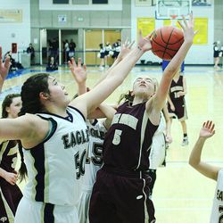 Skyline's Cameron Mooney and Maple Mountain's Liz Eaton battle for the ball during play Friday, Feb. 20, 2015, in 4A semifinal action at Salt Lake Community College in Taylorsville. Skyline won 56-39.
