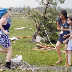 A parent rushes to embrace her child as a teacher escorts her away from Briarwood Elementary school after a tornado destroyed the school in south  Oklahoma City, Okla, Monday, May 20, 2013. Near SW 149th and Hudson. 