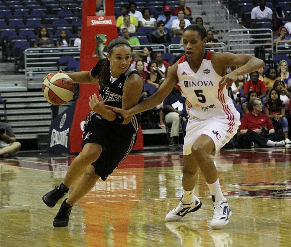 Becky Hammon of the San Antonio Stars drives against Jasmine Thomas of the Washington Mystics in 2012.