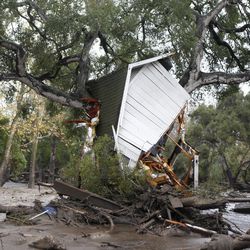 A structure is smashed against a tree along Hot Springs Road in Montecito, Calif. after getting hit by a flash flood and debris flow on Tuesday, Jan. 9, 2018. Several homes were swept away before dawn Tuesday when mud and debris roared into neighborhoods in Montecito from hillsides stripped of vegetation during a recent wildfire. (Daniel Dreifuss)