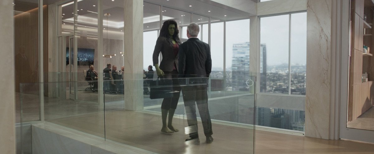 She-Hulk standing in an office getting startled by her boss