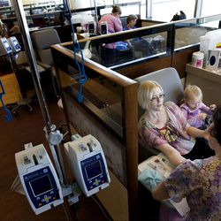 Megan Pilling's daughter, Makena, keeps her company during chemotherapy at the IMC in Murray on Tuesday, Jan. 17, 2012.