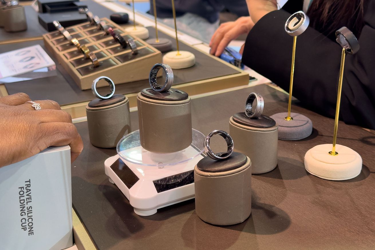 Several J-Style Smart rings arranged in a display case at CES