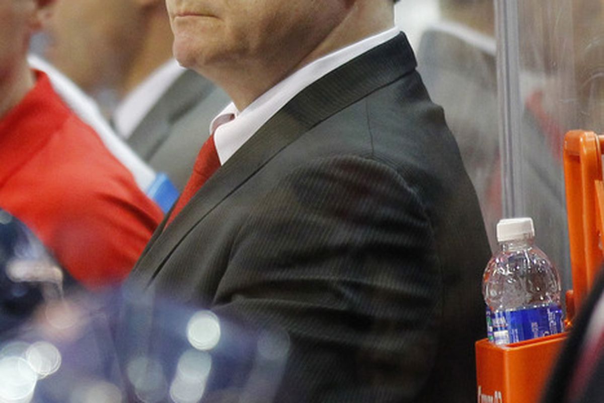 March 27, 2012; Washington, DC, USA; Washington Capitals head coach Dale Hunter watches from behind the bench against the Buffalo Sabres in the second period at Verizon Center. The Sabres won 5-1. Mandatory Credit: Geoff Burke-US PRESSWIRE