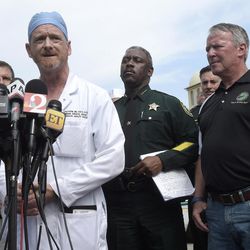 Dr. Michael Cheatham, chief surgeon of the Orlando Health Regional Medical Center hospital, addresses reporters during a news conference after a shooting involving multiple fatalities at a nightclub in Orlando, Fla., Sunday, June 12, 2016. Watching are Orange County Sheriff Jerry Demings, second from right, and Orlando Mayor Buddy Dyer. 