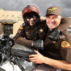 Sgt. Donovan Lucas of the Utah Highway Patrol headlocks Col. Dan Fuhr Tuesday, Feb. 10, 2015, during a photo shoot in Murray.