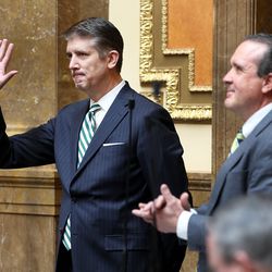 Outgoing Utah Valley University President Matthew S. Holland waves as Rep. Brad Daw, R-Orem, presents a resolution honoring Holland on the House floor at the Capitol in Salt Lake City on Monday, Feb. 26, 2018. The House and Senate unanimously passed a resolution honoring Holland, who is resigning from the Orem-based school to become an LDS Church mission president in North Carolina.