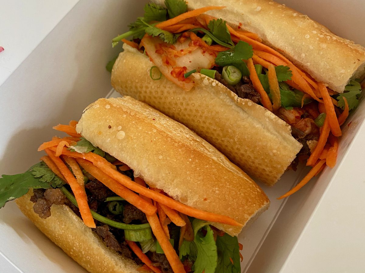 banh mi cut in two in a takeout box