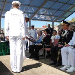 Rear Adm. John Fuller, Navy Region Hawaii commander, presents a flag to LeeAnn Michalske, the niece of machinist’s mate Petty Officer 1st Class Vernon Luke of Green Bay, Wis., a sailor killed in the attack on Pearl Harbor, at his funeral service, Wednesday, March 9, 2016 in Honolulu. The 43-year-old was killed when Japanese planes bombed his battleship, the USS Oklahoma on Dec. 7, 1941. After World War II, he was buried as an “unknown” along with nearly 400 other unidentified sailors and Marines from the battleship. 