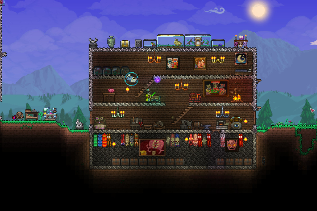 A Terraria house made of stone with wood walls. It’s several floors high and has staircases leading up to different areas.
