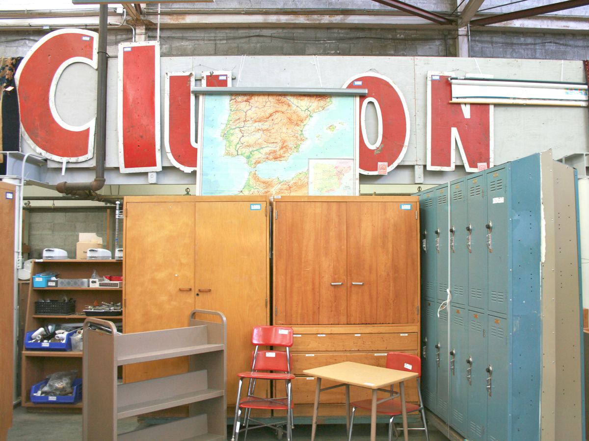 A variety of furniture objects under a series of standalone red letters, partially obscured by a map, but read “Clu” on one side and “ON” on the other.
