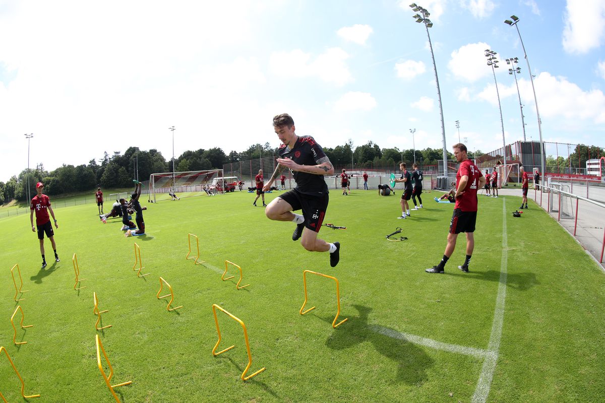Adrian Fein jumps over a series of obstacles at Bayern training in 2021