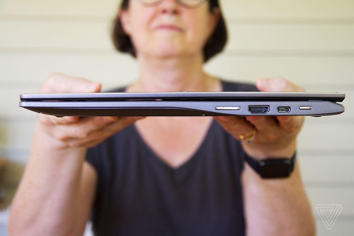 A user holds up the Acer Chromebook Spin 713 facing the right.