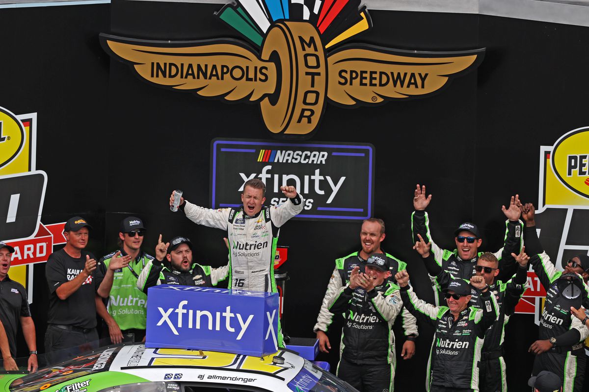 NASCAR Xfinity series driver AJ Allmendinger (16) celebrates with his team after winning the Pennzoil 150 at the Brickyard on July 30, 2022 at the Indianapolis Motor Speedway Road Course in Indianapolis, Indiana.