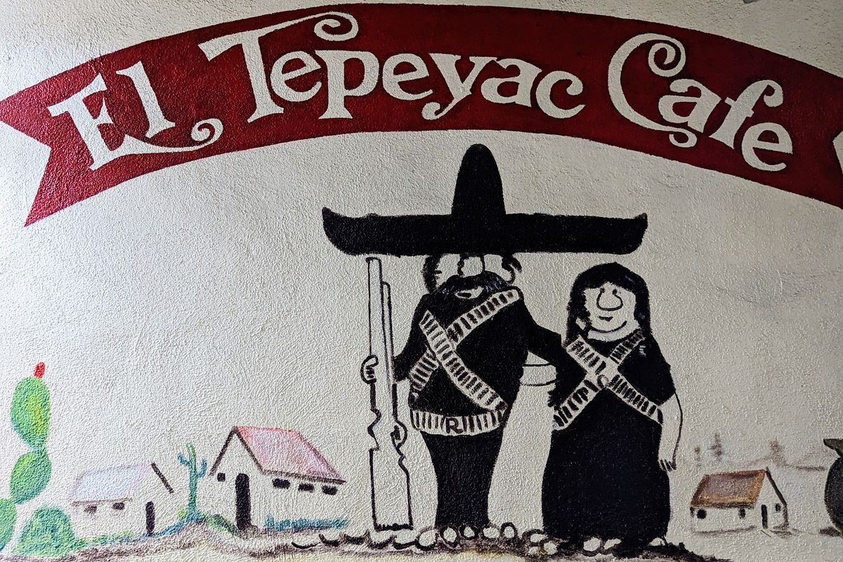 Mural of a traditional Mexican American restaurant sign in LA with man and woman illustrated.