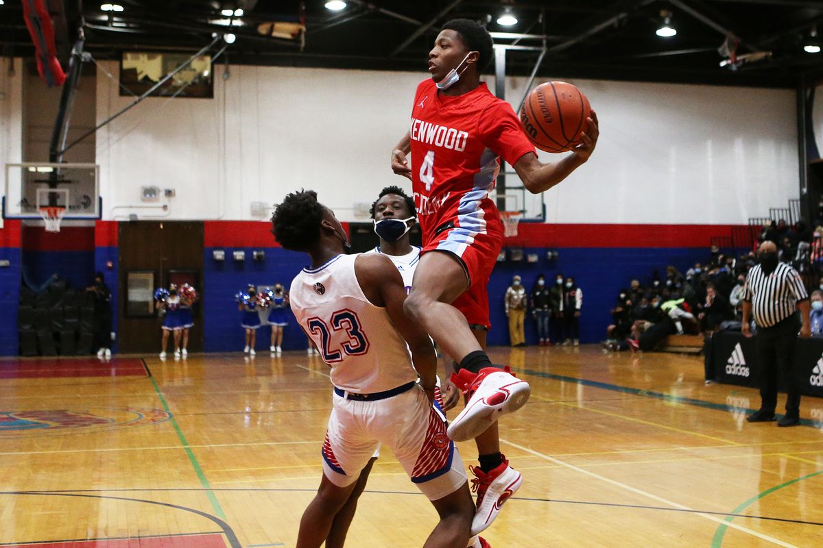 Kenwood’s Darrin Ames (4) drives and looks to pass as Curie’s Chikasi Ofoma (23) defends.