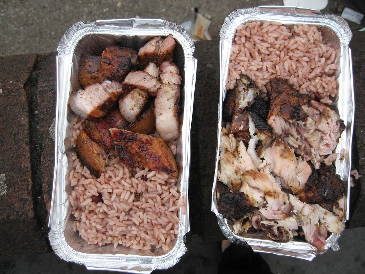 Two takeout containers of chopped jerked meat with rice. 
