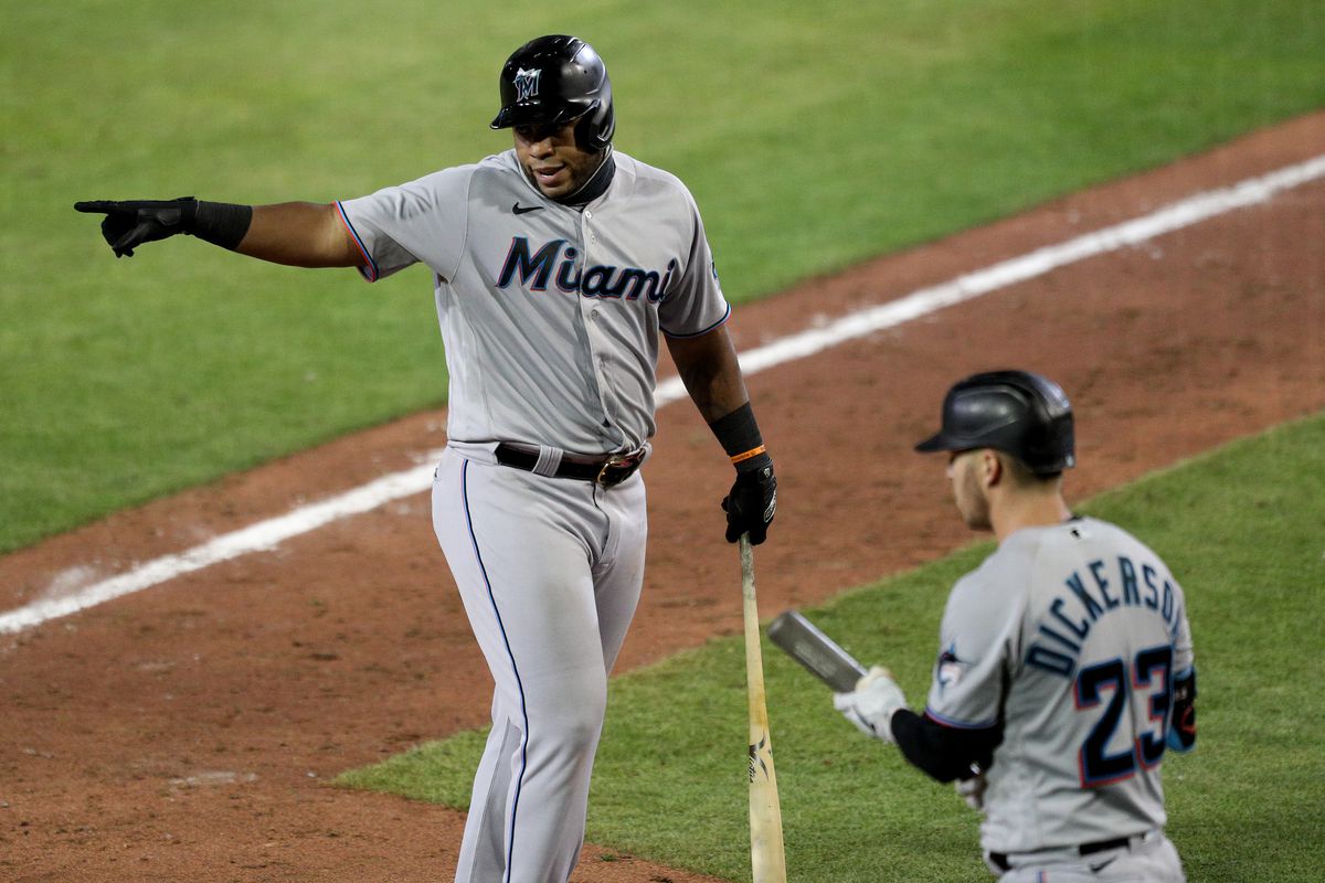 Jesus Aguilar #24 of the Miami Marlins argues with umpire Roberto Ortiz #40 after a called third strike during the eighth inning of an MLB game against the Toronto Blue Jays at Sahlen Field on August 12, 2020