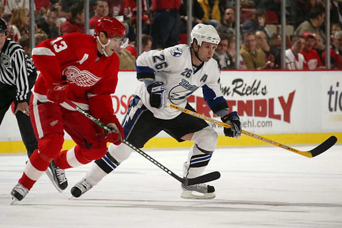 Pavel Datsyuk and Martin St. Louis race for the puck at Joe Louis Arena in this file photo dated November 29, 2007 (Photo by Dave Sandford/Getty Images)