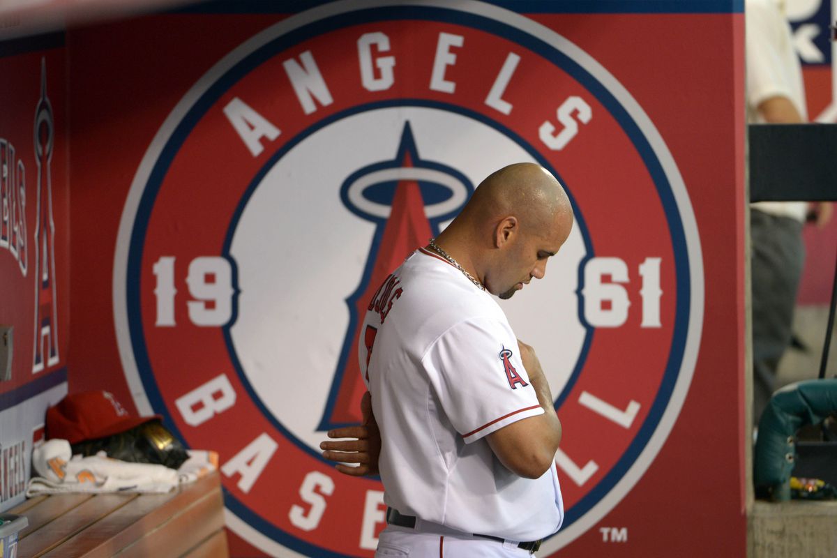 Sep 12, 2012; Anaheim, CA, USA; Los Angeles Angels designated hitter Albert Pujols (5) observes the playing of the national anthem before the game against the Oakland Athletics at Angel Stadium. Mandatory Credit: Kirby Lee/Image of Sport-US PRESSWIRE