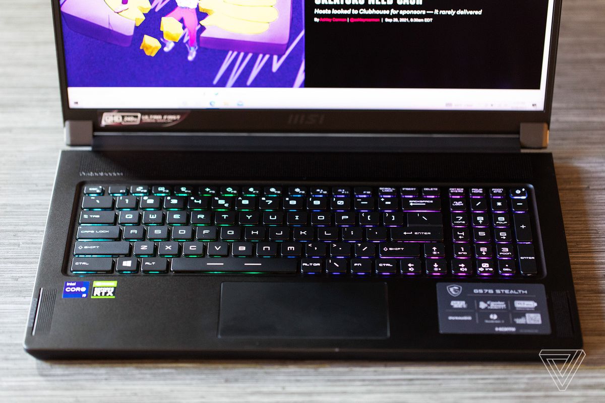 The MSI GS76 Stealth keyboard seen from above, illuminated in green and pink.