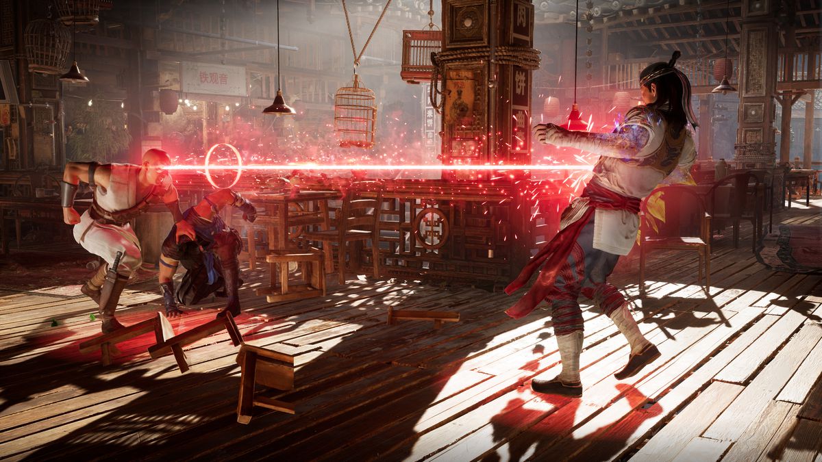 Kano fires his eye beam at Liu Kang, protecting Sub-Zero while doing so, in a screenshot from Mortal Kombat 1