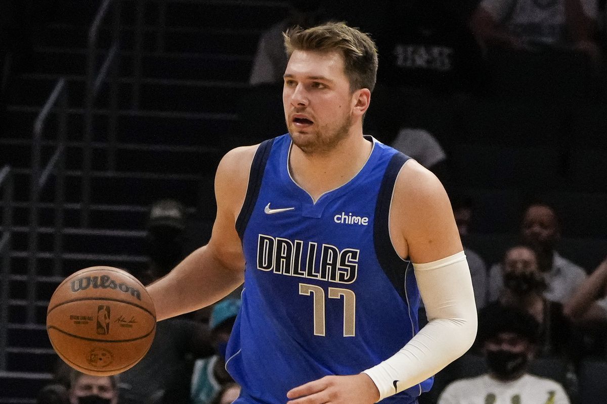 Dallas Mavericks guard Luka Doncic (77) brings the ball up court against the Charlotte Hornets during the first half at Spectrum Center.