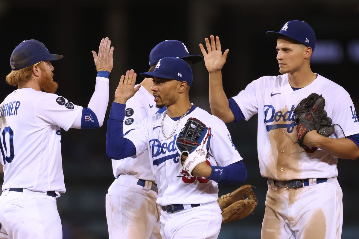 Mookie Betts #50, Justin Turner #10, Trea Turner #6 and Corey Seager #5 celebrate an 8-3 win over the San Diego Padres at Dodger Stadium on September 30, 2021 in Los Angeles, California.