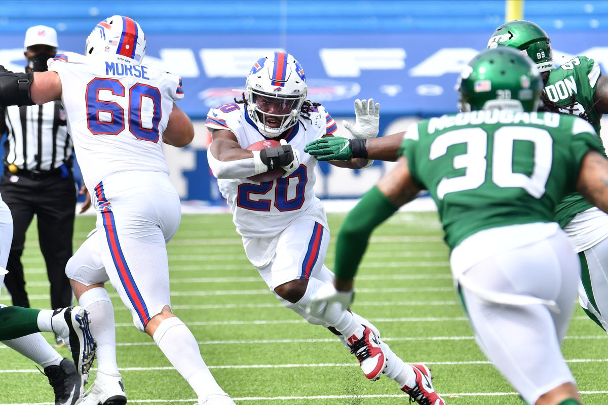 Buffalo Bills running back Zack Moss runs through a hole as #30 looks to make a tackle during the second quarter at Bills Stadium.