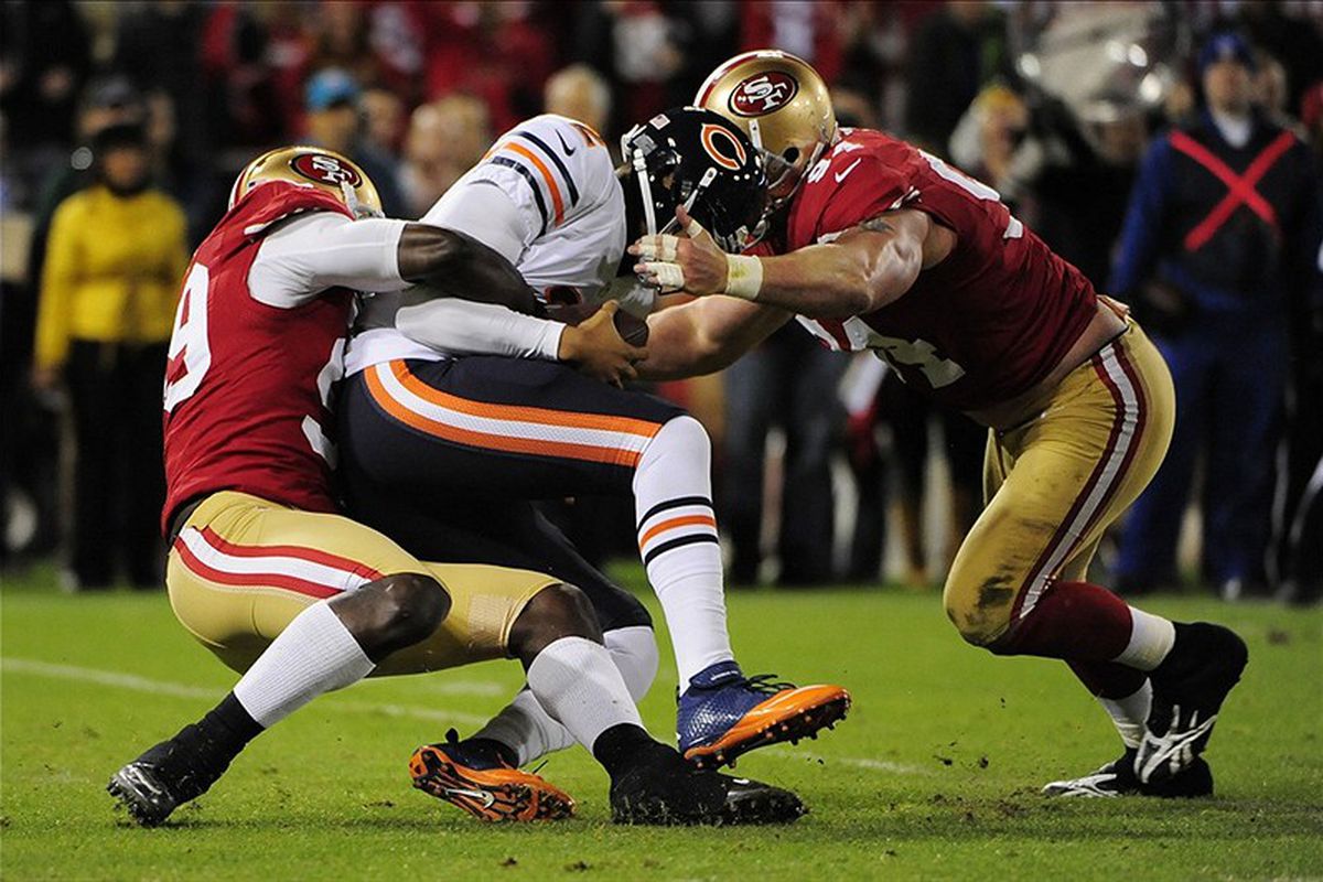 Chicago Bears quarterback Jason Campbell (2) is sacked by San Francisco 49ers outside linebacker Aldon Smith (99, left) and defensive end Justin Smith (94, right) during the first quarter at Candlestick Park.