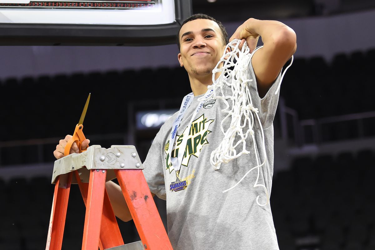 North Dakota State Bison guard Tyson Ward (24) cuts down the net after the win against the North Dakota Fighting Hawks at Denny Sanford Premier Center.