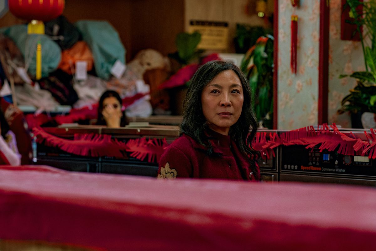 Michelle Yeoh stands in the family laundromat in Everything Everywhere All At Once