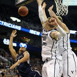 Utah State Aggies guard Marcel Davis (0) shoots around the Brigham Young Cougars defense including Brigham Young Cougars forward Nate Austin (33) during a game at EnergySolutions Arena on Saturday, November 30, 2013.